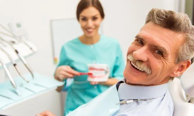 man and dentist smilling